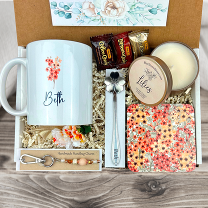  gift basket with a blush floral personalized coffee mug, engraved spoon, vibrant coaster, scented candle, artisan charm, and coffee treats for women’s